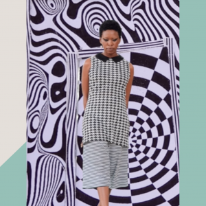 Natalie Paneng, a black woman with short hair, wearing a black and white small pattern top and pants against a black and white eye illusion background